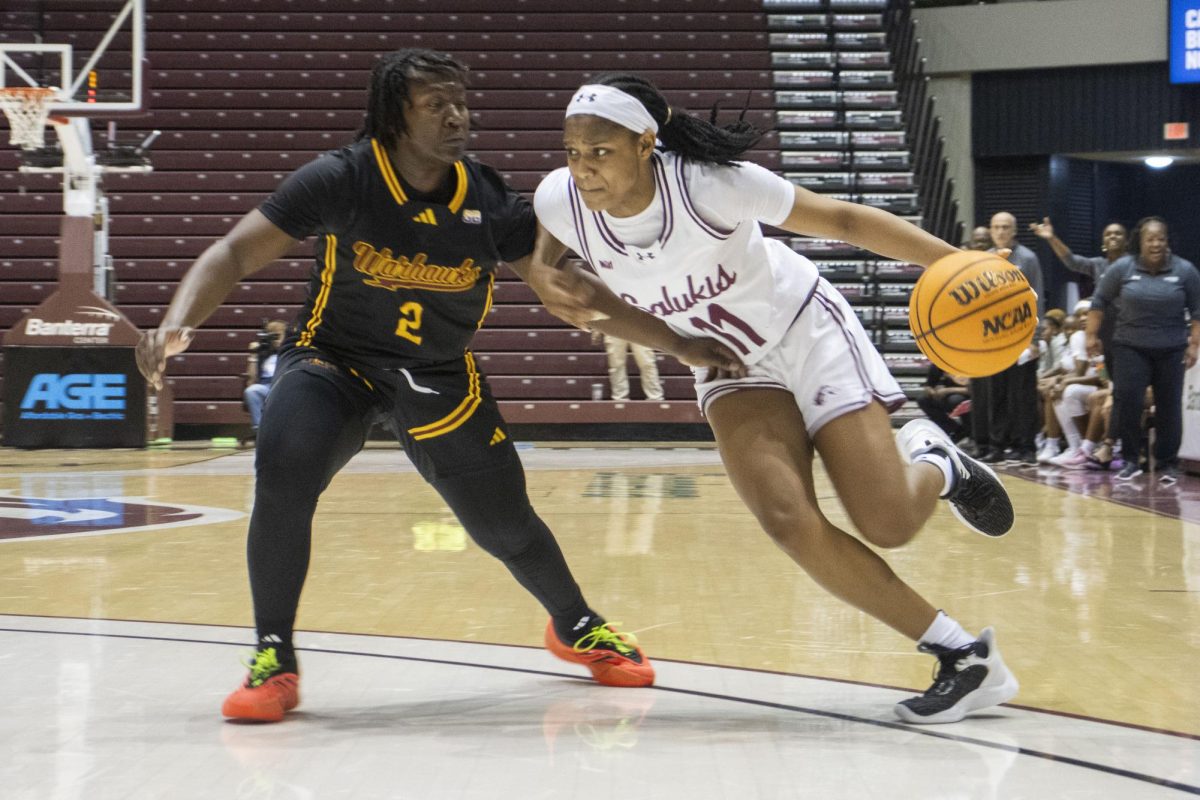 Kayla Cooper (11) drives the ball towards the basket as the Salukis face ULM at home Nov. 12, 2024 at Banterra Center in Carbondale, Illinois. 