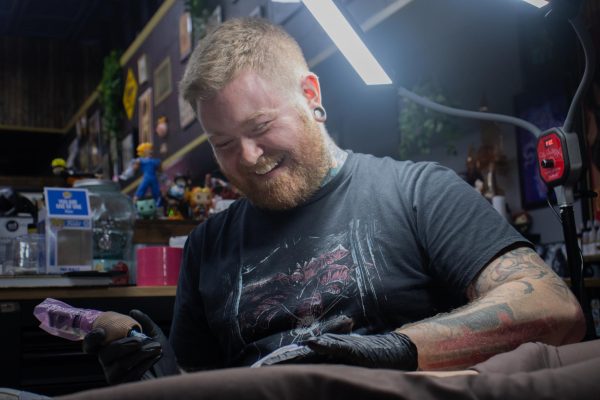 Matt Stanton tattoos a leg of a customer at Neon Tiger Tattoos Nov. 14, 2024 in Carbondale Illinois. 
