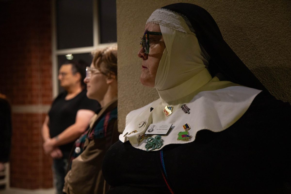 SOIL Sister of Perpetual Indulgence Maggie Degen, also known as Gay Bitch Milkshake, listens as a fellow speaker at the Power in Unity event speaks Nov. 8, 2024 at the Carbondale Civic Center in Carbondale, Illinois.