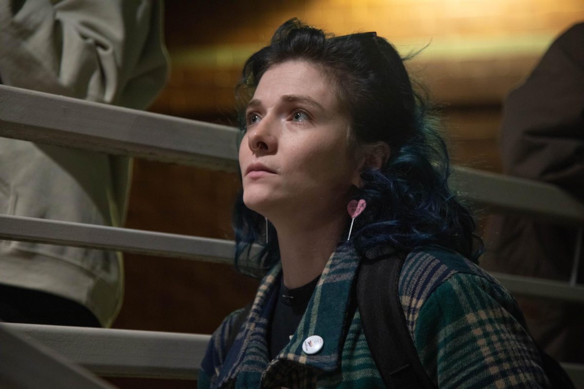 Ellen Booth stares up teary-eyed at a speaker at the Power in Unity event held by Pride in Action, Southern Il Nov. 8, 2024 at the Carbondale Civic Center in Carbondale, Illinois. The Pride in Unity event was organized in response to Trump's election win in the 2024 General Election and concerns of what will come of LGBTQIA+ rights in the next four years. 