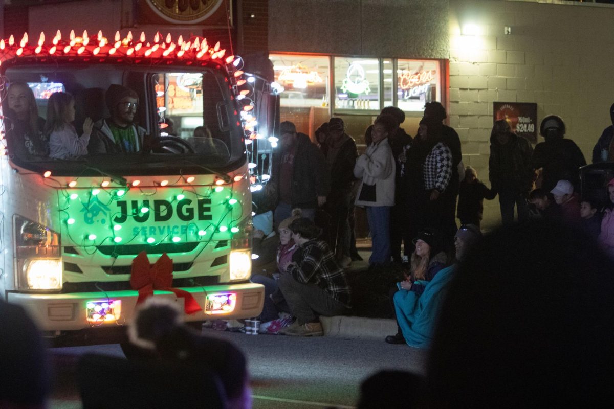 A truck, decked with lights, drives down Illinois Avenue in the Lights Fantastic Parade Dec. 7, 2024 on the Strip in Carbondale, Illinois.