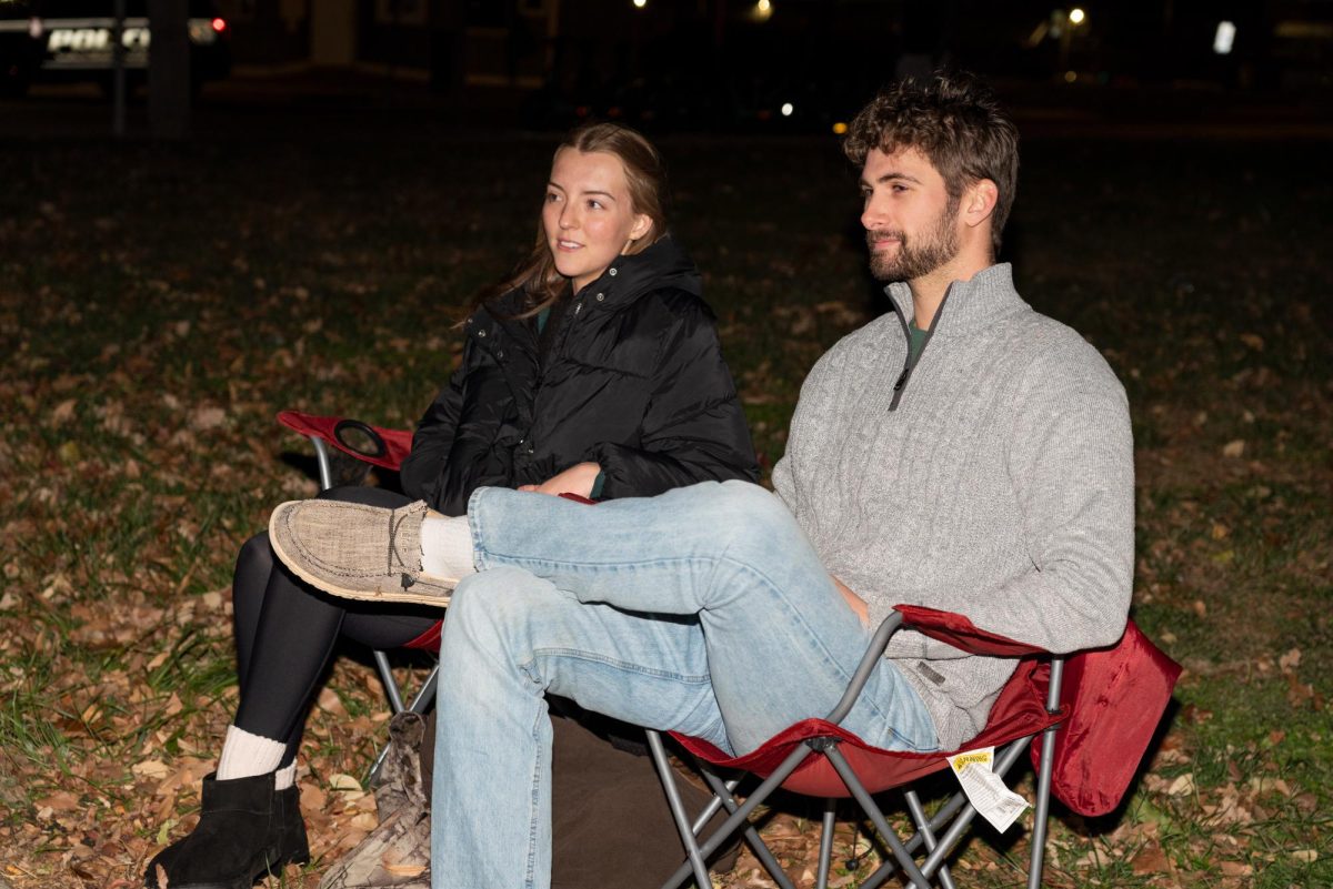 Luke Falgout and his girlfriend Molly Smith from Cobden, Illinois come to watch the Lights Fantastic Parade across the Strip Dec. 7, 2024 in Carbondale, Illinois. 