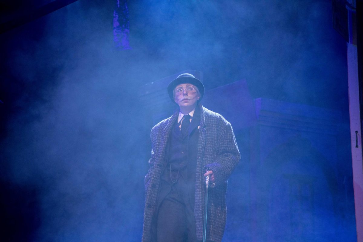 Ebenezer Scrooge (Sawyer Richman) looks around as he leaves his business to go home Dec. 4, 2024 at McLeod Theater in Carbondale, Illinois. 