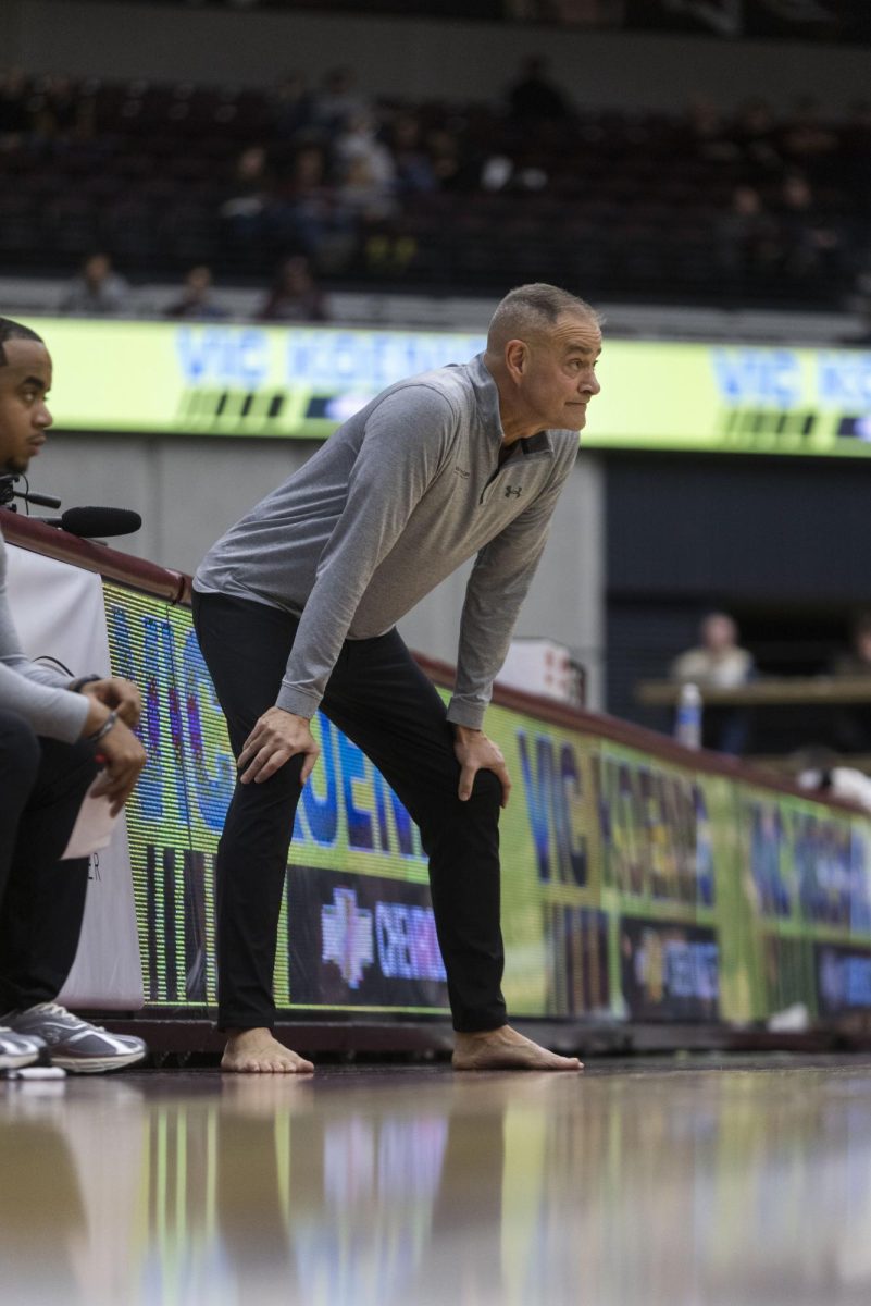 Coach Scott Nagy coaches from the sidelines barefoot to raise awareness for Samaritan’s Feet Jan. 11, 2025 at Banterra Center in Carbondale, Illinois. Nagy brought the tradition of coaching one game a year barefoot with him to SIU. The game works to spotlight the need for shoes worldwide. Fans could support the cause through the university’s virtual shoe drive, sponsored by Samaritan’s Feet International.