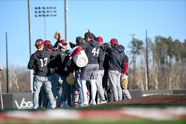 Saluki baseball huddle together during a practice Jan. 24, 2025 at Itchy Jones Stadium in Carbondale, Illinois.