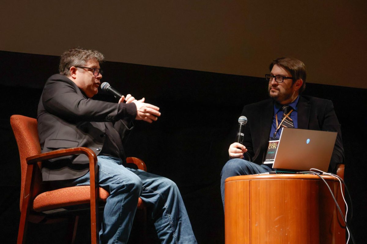 Sean Astin (left), an actor and filmmaker best known for his roles in ‘The Goonies,’ ‘Lord of the Rings’ and ‘Stranger Things,’ sits while being interviewed by (name) during the Special Speaker event of Saluki Con Feb. 15, 2025 at Shryock Auditorium in Carbondale, Illinois. 