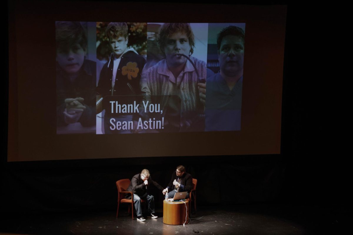 Sean Astin recites a monologue from his time on ‘Lord of the Rings’ while a collage from his past roles is projected on the screen behind him as a thank you for attending Saluki Con Feb. 15, 2025 at Shryock Auditorium in Carbondale, Illinois.