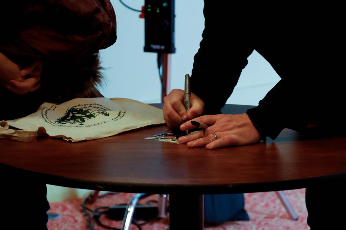 Sean Astin autographs a photograph during a meet and greet following the Saluki Con Special Speaker event Feb. 15, 2025 at Shryock Auditorium in Carbondale, Illinois. 