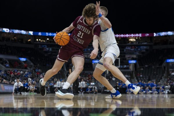 Saluki guard Drew Steffe (21) pushes against Drake Bulldog guard Bennett Stirtz (14) as he drives towards the basket in an Arch Madness quarterfinal game March 7, 2025 at Enterprise Center in St. Louis, Missouri. 