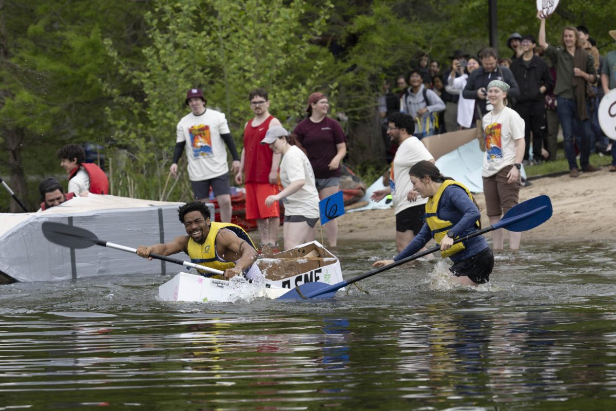 The  ASME Goofy Goobers team members Christian Smith and Faith Loyd try to make it off shore at the 50th Cardboard Boat Regatta in campus lake April 26, 2025 in Carbondale, Illinois. 