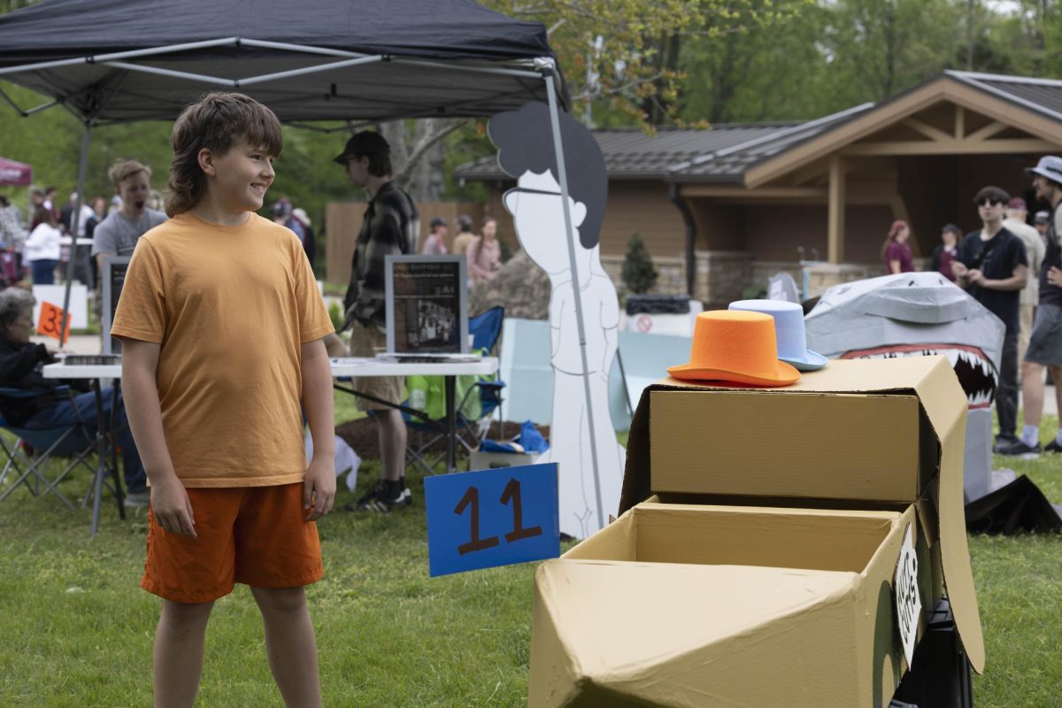 Cooper Jones stands next to his boat called "Dumb and Dumb(car)" at the Cardboard Boat Regatta April 26, 2025 in Carbondale, Illinois. 