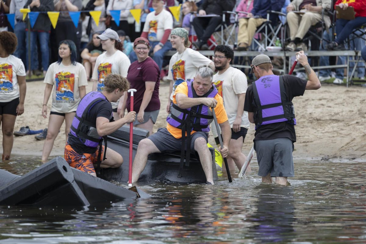 The "Just Boat" team try to paddle away from shore at the 50th Annual Cardboard Boat Regatta in campus lake April 26, 2025 in Carbondale, Illinois. 