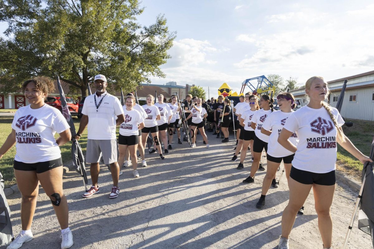 Saluki Silks stand at attention with Chancellor Lane before the Twilight Parade starts at the Du Quoin State fair Aug. 22, 2025 Du Quoin, Illinois. 