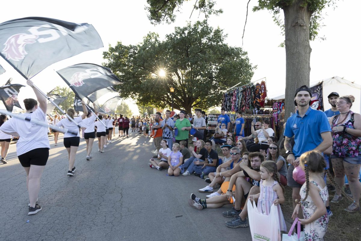 Du Quoin State fair visitors sit and watch as SIU Marching Saluki's perform school song Aug. 22, 2025 Du Quoin, Illinois. 