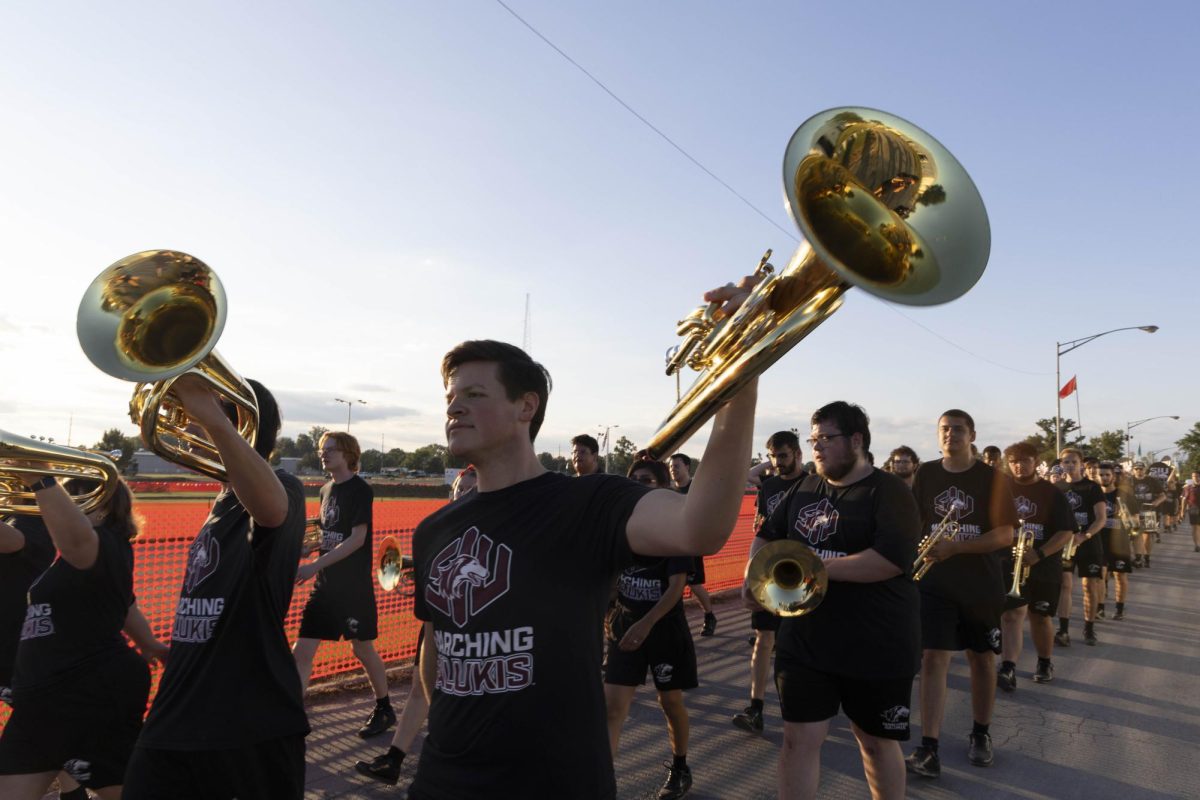 Baritone Section Leader Harrison Braddy lifts his baritone up with the cadence at the end of the Twilight Parade at the Du Quoin State fair Aug. 22, 2025 Du Quoin, Illinois. 