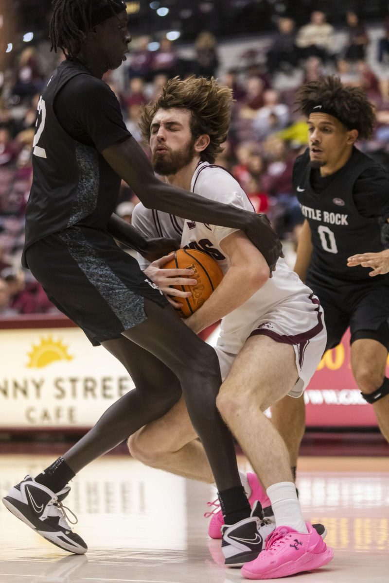 Saluki guard Drew Steffe (21) pushes through Trojan defense as he moves towards the basket while SIU faces Little Rock at home Nov. 29, 2925 at Banterra Center in Carbondale, Illinois. 