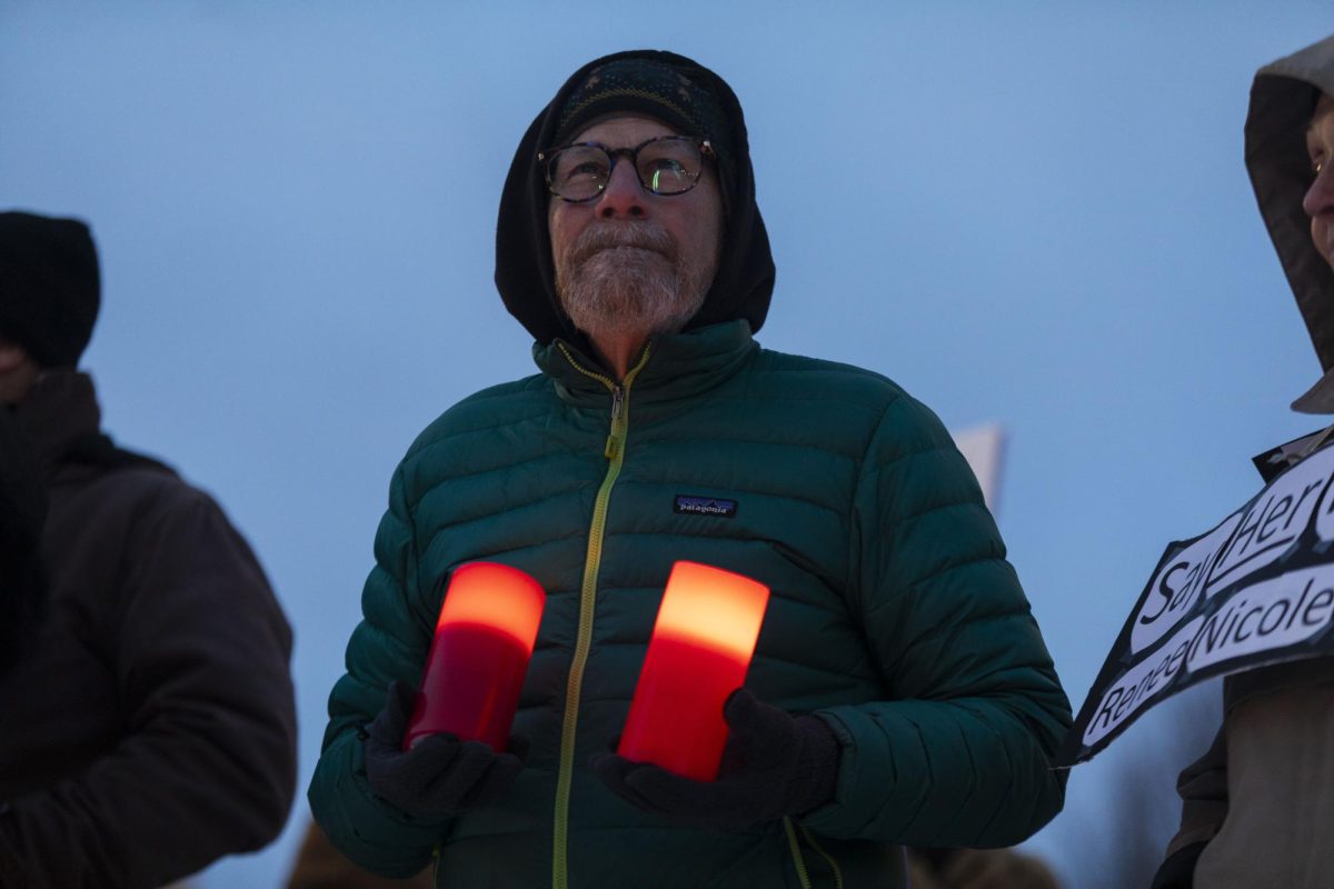 Joe Powers, of Carbondale, holds candles as he stands with other members of the Marion and Carbondale community at an evening candlelight vigil Jan. 31, 2026 in Marion, Illinois. The vigil was held for Alex Pretti who was killed by an ICE agent in Minneapolis, Minnesota.
