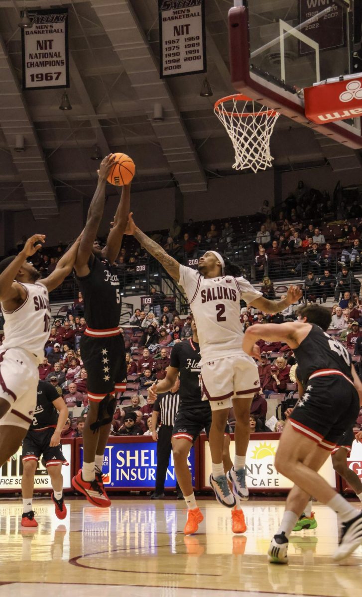 Southern Illinois' Quel'ron House (2) goes up for a rebound against UIC's Rashund Washington Jr. (5) during the Salukis' game Jan. 31, 2026 at the Banterra Center in Carbondale, Illinois. 