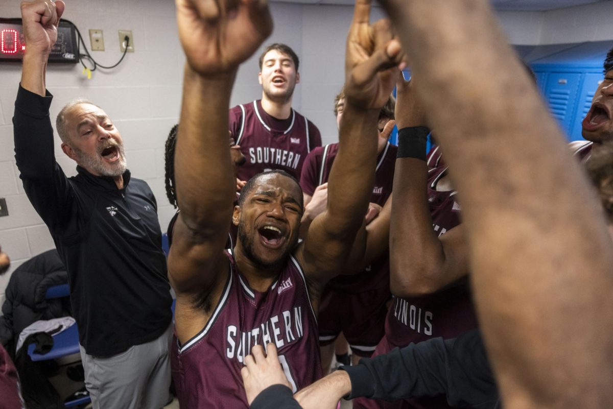 SIU guard Damien Mayo Jr. (0) celebrates in the locker room surrounded by the SIU men's basketball team after the Salukis made a 68-67 buzzer-beater win over the Belmont Bruins Jan. 4, 2026 at Curb Event Center in Nashville, Tennessee. 