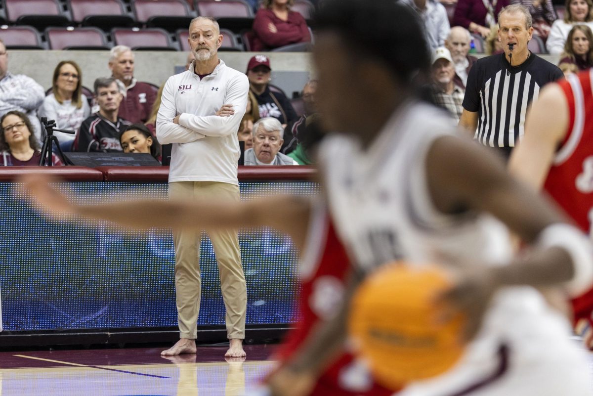 Head coach Scott Nagy coaches barefoot from the sidelines as the Salukis face off against the Bradley Braves Feb. 15, 2026 at Banterra Center in Carbondale, Illinois.