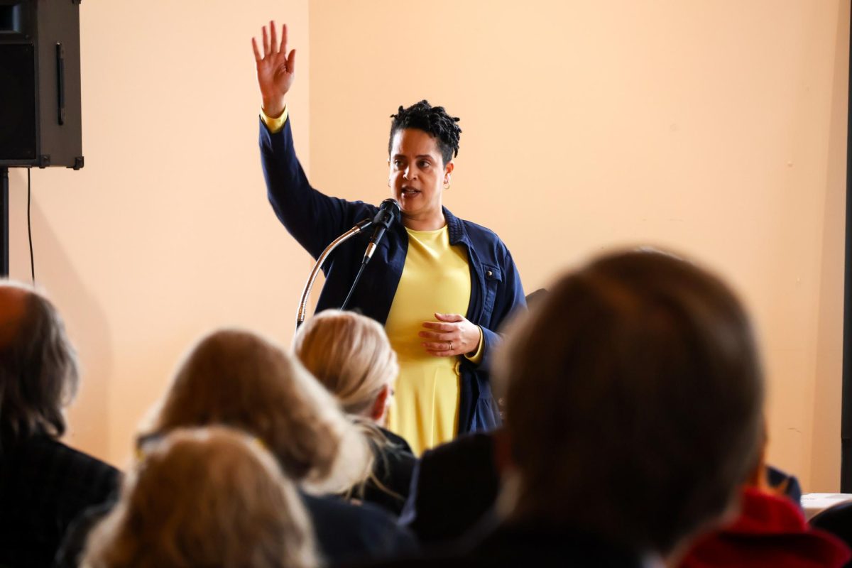 Chief Homelessness Officer, Christine Haley of the Illinois Office to Prevent and End Homelessness within the Illinois Department of Human Services, gestures for attendees to raise their hands if they would like to speak during a town hall meeting at First Presbyterian Church Feb. 25, 2026 in Carbondale, Illinois.