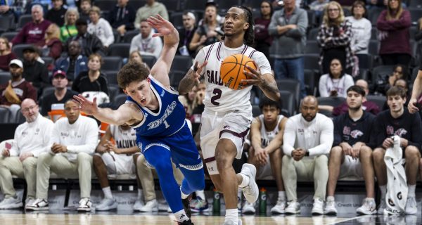 SIU guard Quel’Ron House (2) looks towards the basket as Drake guard Owen Larson (1) guards him in the opening round of Arch Madness March 5, 2026 at the Enterprise Center in St. Louis, Missouri.