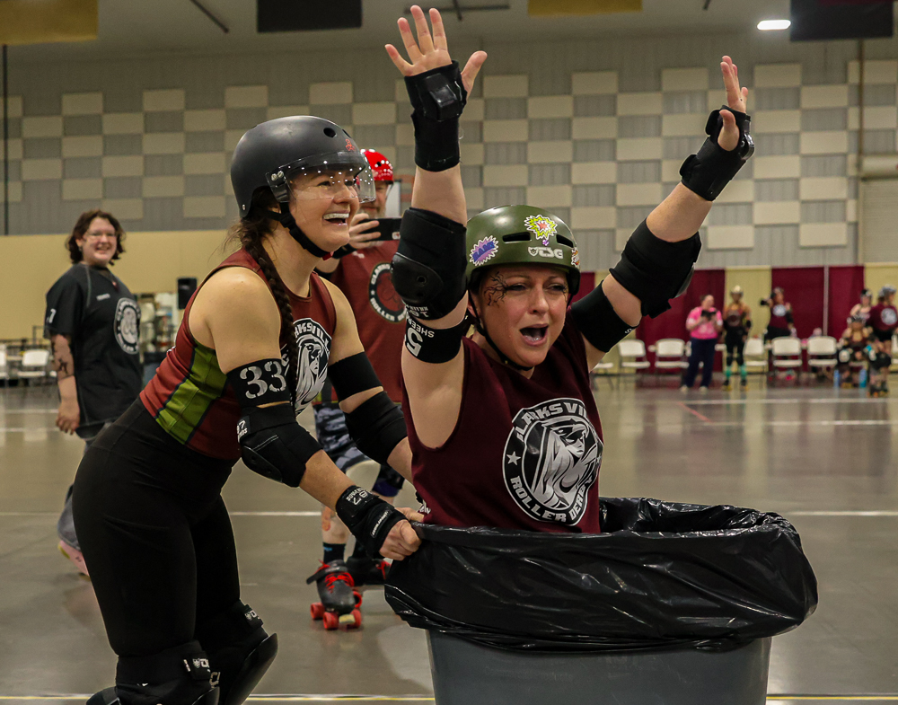Sugaree (33) pushes Sheeroy Jenkins (579) in a garbage can around the play area before the first match of roller derby March 14, 2026 at the Pavilion in Marion, Illinois. 