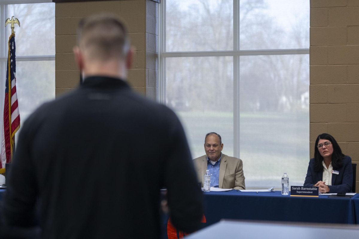 A father with children in the Carterville school district questions officials during a March board of education meeting about why they had not acted sooner to place an assistant football coach, accused of sexual abuse, on leave. Lylee Gibbs | @lyleegibbsphoto