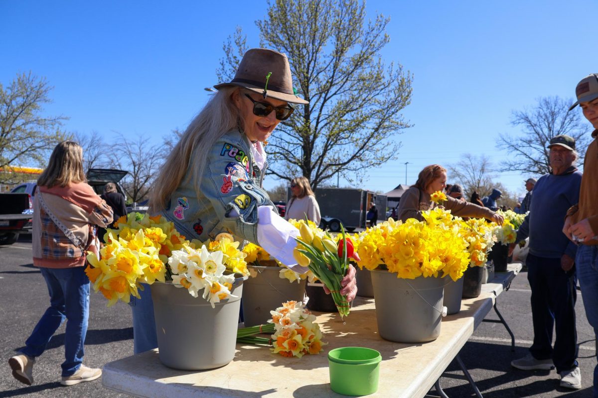 Elena Floyd-Kennett shops for daffodils and tulips March, 28, 2026 at the Carbondale Farmers Market near the Murdale Shopping Center in Carbondale, Illinois.