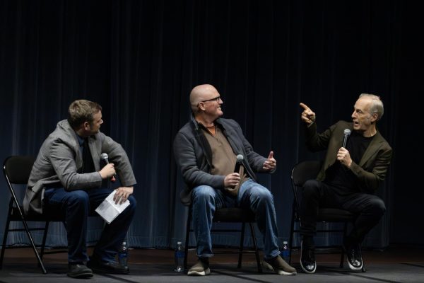"Normal" star Bob Odenkirk (right) points at "Normal" screenwriter Derek Kolstad during a discussion moderated by WGLT content director Ryan Denham (left) April 2, 2026 at the Normal Theater in Normal, Illinois. 