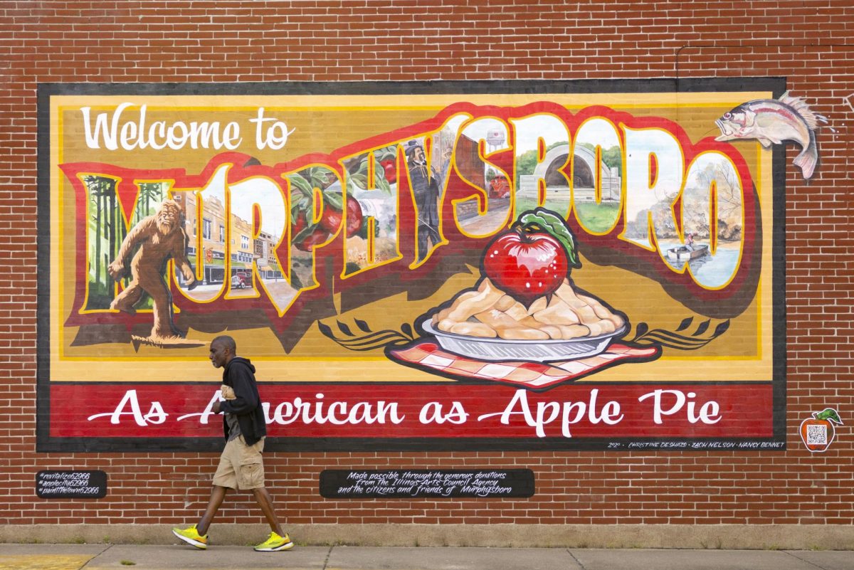 Anthony Hunter walks past the 'Welcome to Murphysboro' mural on the corner of 14th & Walnut Street in Murphysboro, Illinois, Saturday, April 11, 2026.