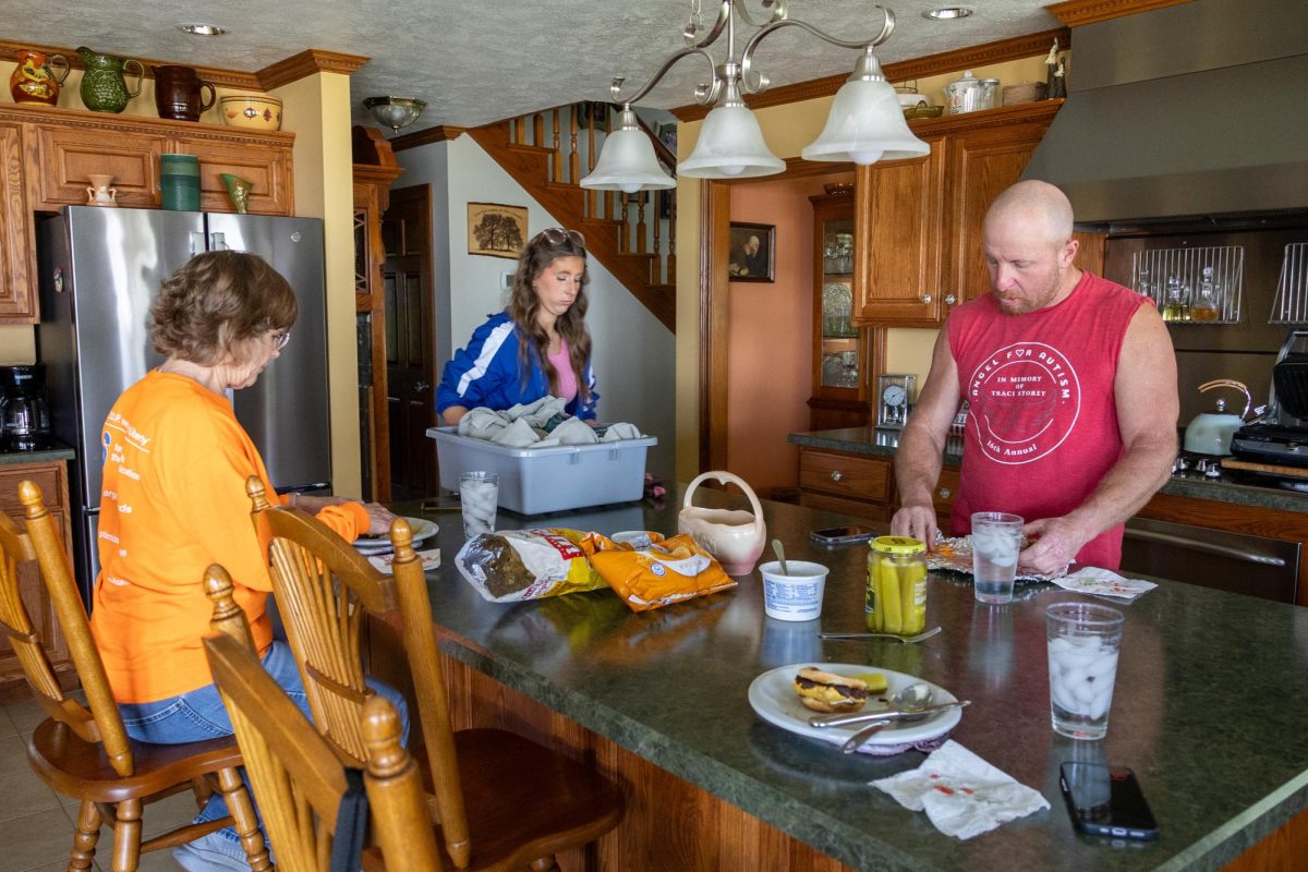 Jane and Gary Tretter eat lunch while Josie Tretter places mason jars on the counter April 11, 2026 at their home in Murphysboro, Illinois.