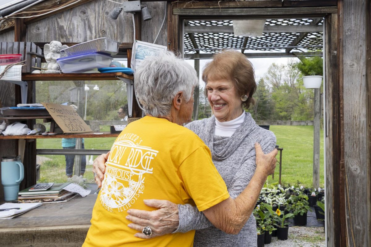 Virginia Rinella, a longtime customer at Hunziker Greenhouse, embraces owner Mary Lou Hunziker April 11, 2026, in Murphysboro, Illinois.