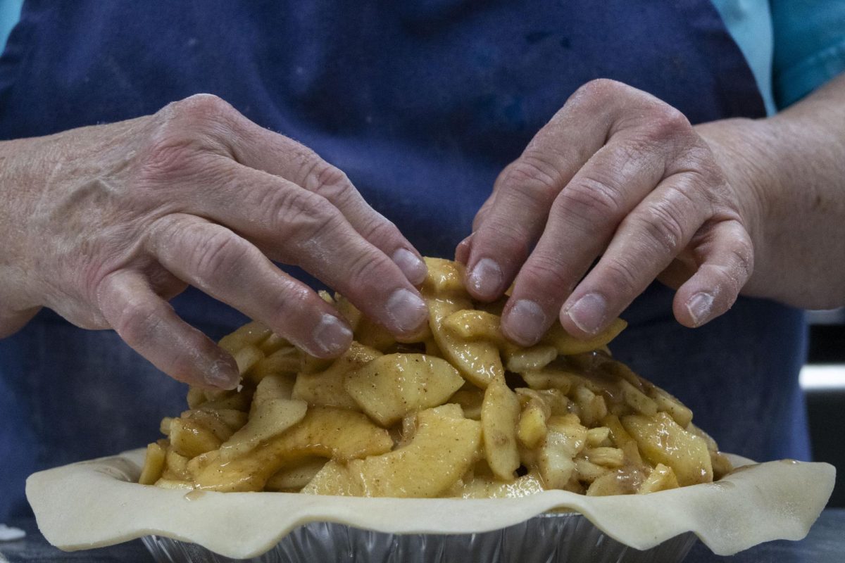 Left: Lisa Mileur, 70, places apples on top of lard dough to make apple pie April 10, 2026 at Mileur Orchard in Murphysboro, Illinois.