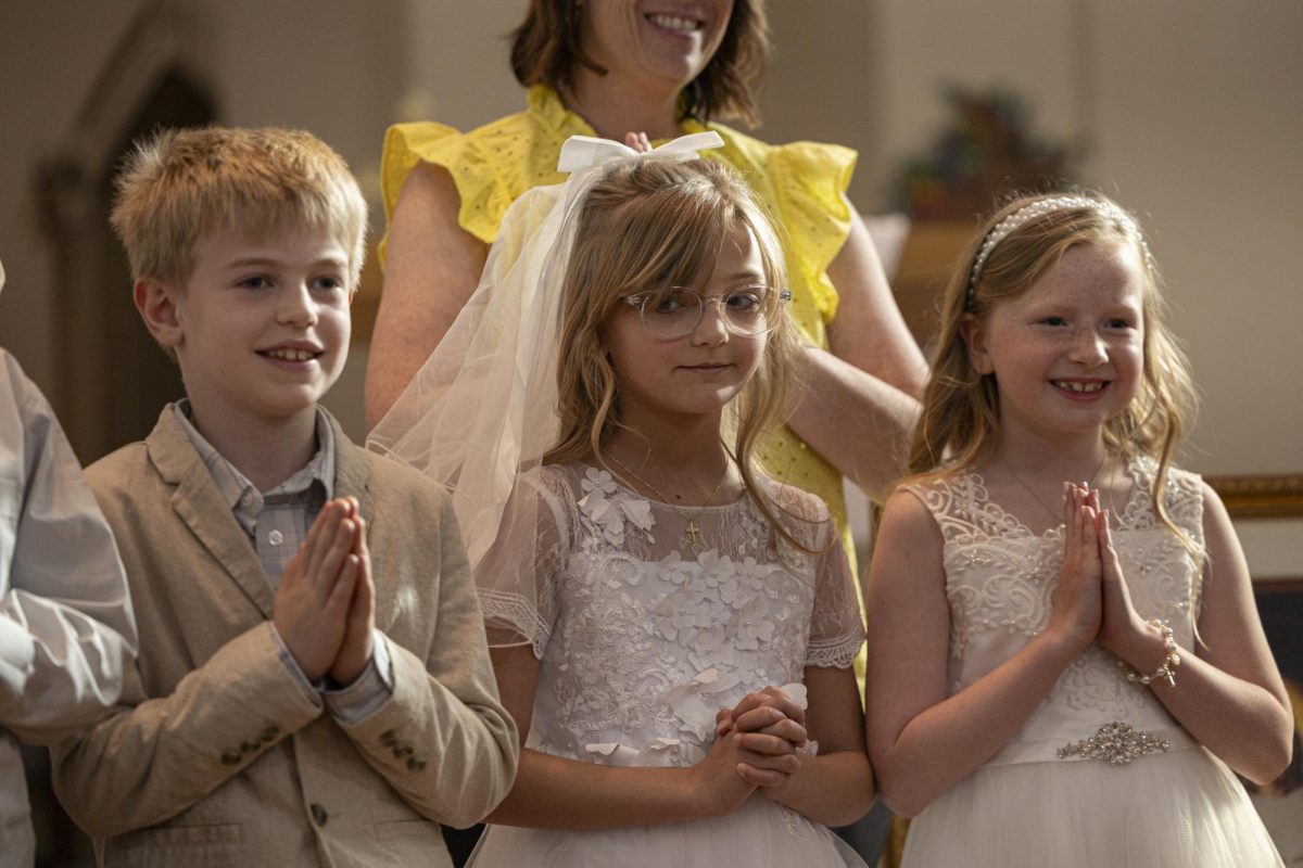 Marcella Haney looks towards Victor Cummings during her first Communion April 11, 2026 at St. Andrew’s Catholic Church in Murphysboro, Illinois.