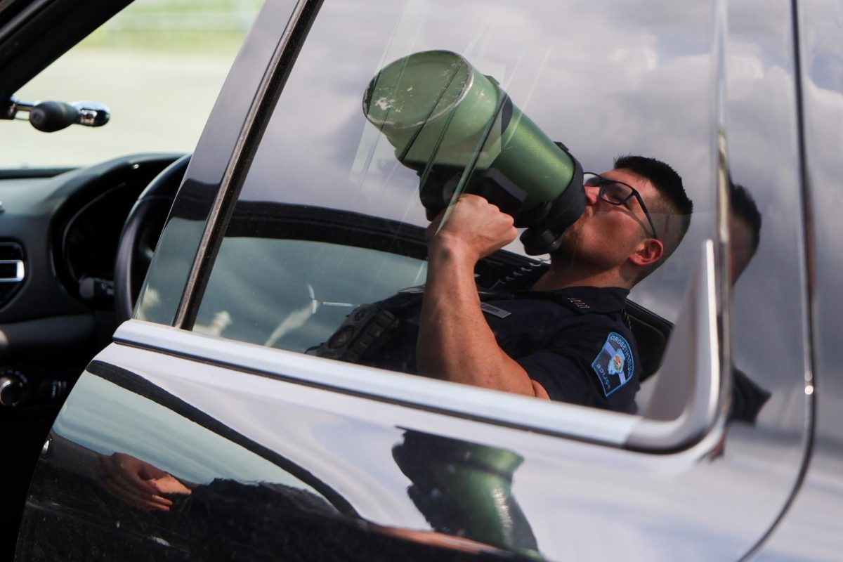 Officer Pingolt drinks from his large water bottle April 10, 2026 while fueling up during his patrol through Murphysboro, Illinois.