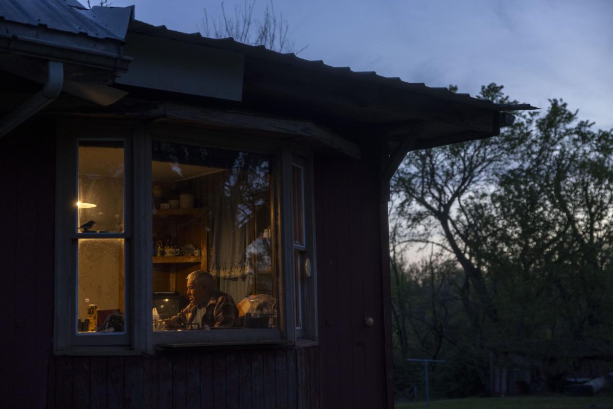 Kenny Moore, 99, sits at his kitchen table late in the evening as the sun sets April 11, 2026 in Murphysboro, Illinois.