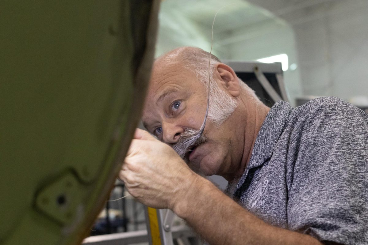 Paul Slosar, a designated airworthiness representative for the Federal Aviation Administration peers into a compartment looking for corrosion April 11, 2026 at the Southern Illinois Airport in Murphysboro, Illinois.