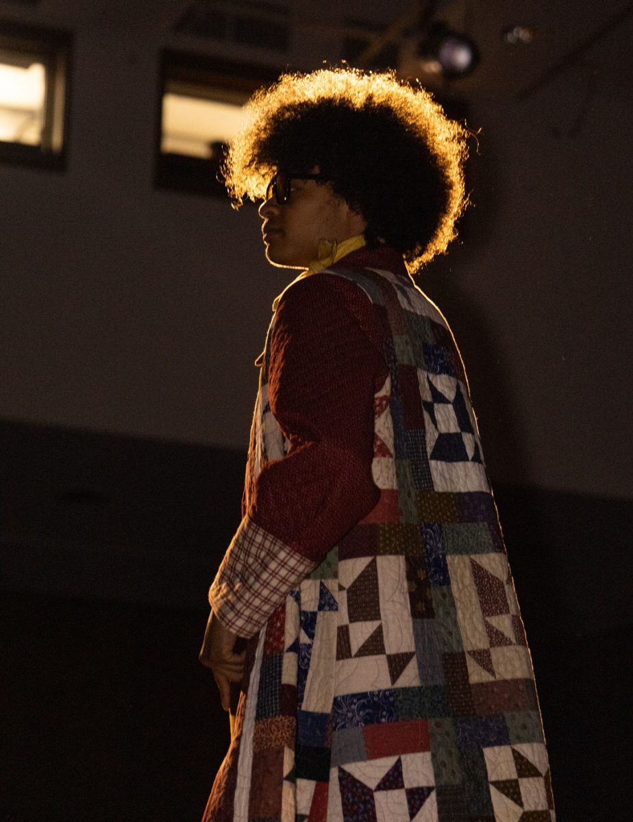Zevin Woods models designer Anna Niemeyer's clothes on the lighted catwalk April 23, 2026 in SIU's student center ballrooms in Carbondale, Illinois.