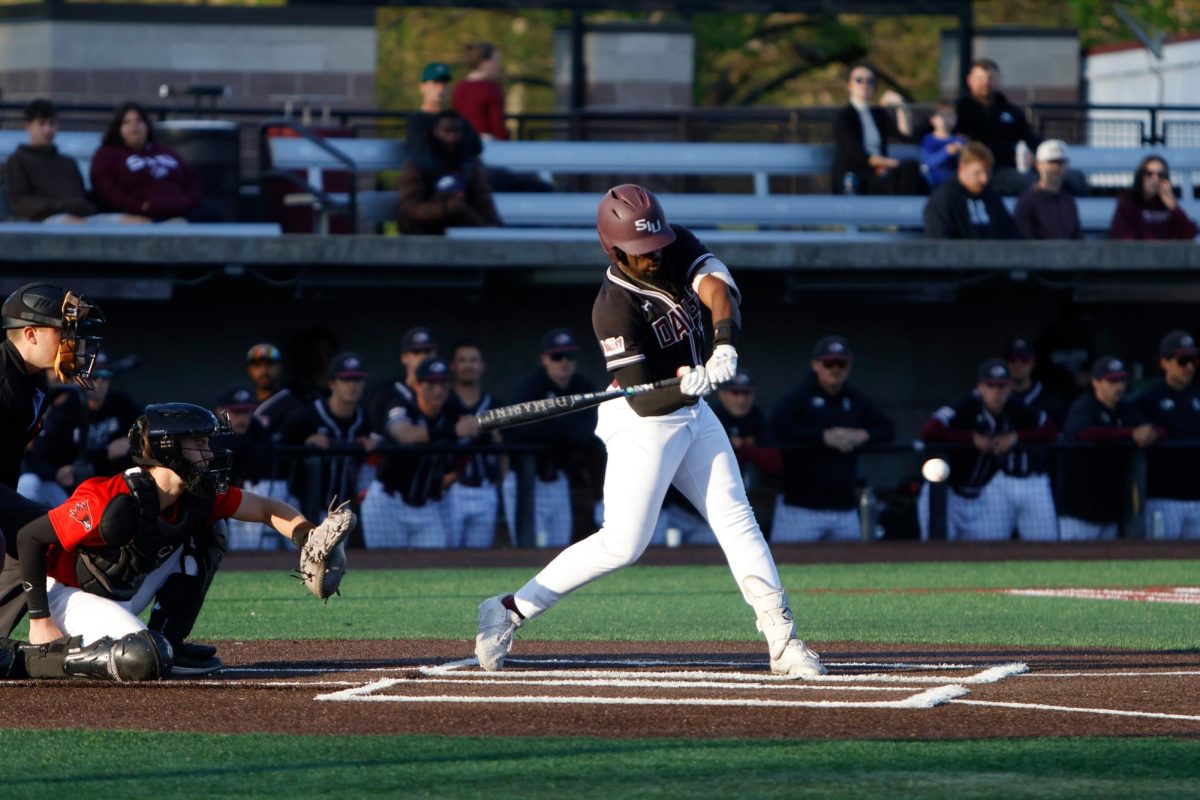 SIU infielder Tim Simay (14) swings his bat at a ball during a game against SEMO April 7, 2026 at Itchy Jones Stadium in Carbondale, Illinois. 