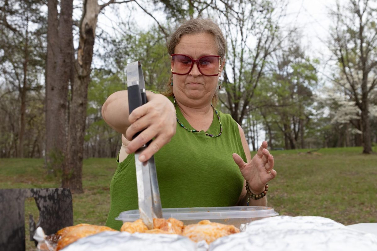 Amanda Allen Hall is originally from Knoxville, Tennessee, and is currently a Murphysboro resident who lives with Alpha-gal syndrome flips a piece of chicken while grilling April 4, 2026 at Lake Murphysboro State Park in Murphysboro, Illinois.