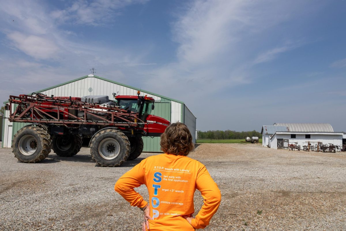 Jane Tretter looks at the herbicide truck while Gary Arthur Tretter and his fiancé Amy Haggerty drive back to the fields to continue spraying April 11, 2026 in Murphysboro, Illinois.