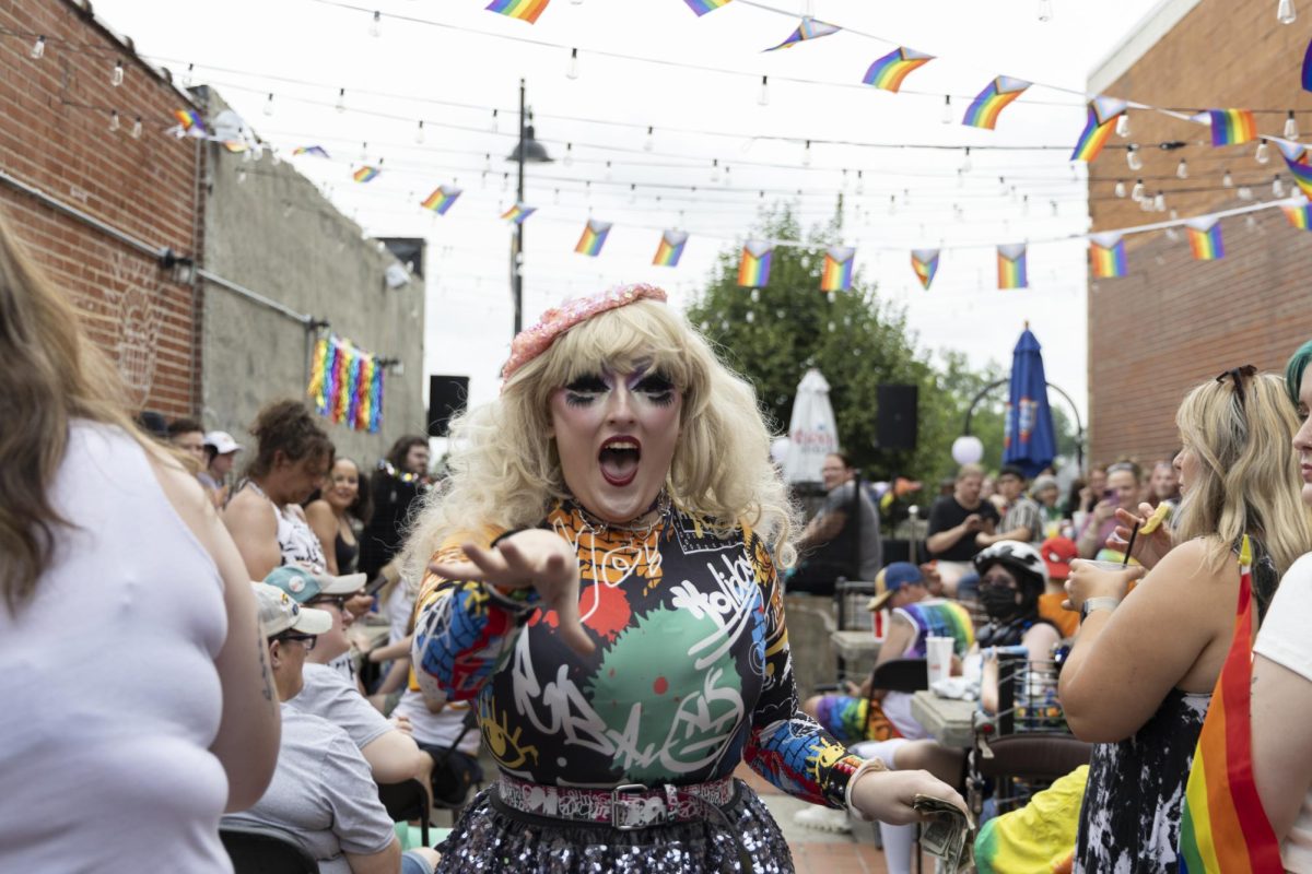 Drag Queen Vendetta Devil motions toward the crowd during the Drag Brunch June 13, 2026 at Booby's Beer Garden in Carbondale, Illinois. Peyton Cook | @cookmeavisual
