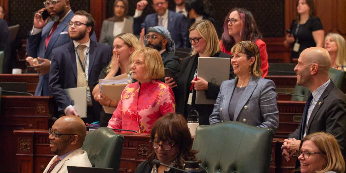 House Democrats surround Rep. Robyn Gabel, D-Evanston, as they vote on the fiscal year 2027 budget in the early hours of June 1, 2026.