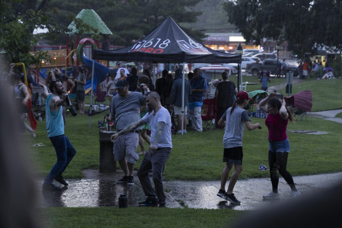 Concert-goers dance in the rain during the sunset concert July 16 at Turley Park in Carbondale, Illinois. Peyton Cook | @cookmeavisual
