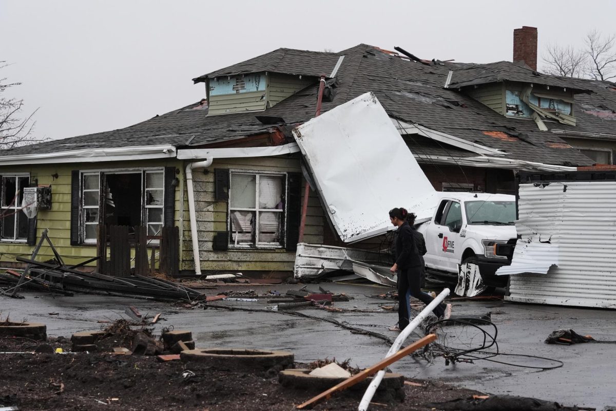People look over damage in the aftermath of a powerful storm that ripped through the area a day earlier in Kankakee on Wednesday, March 11, 2026. (AP Photo/Nam Y. Huh)